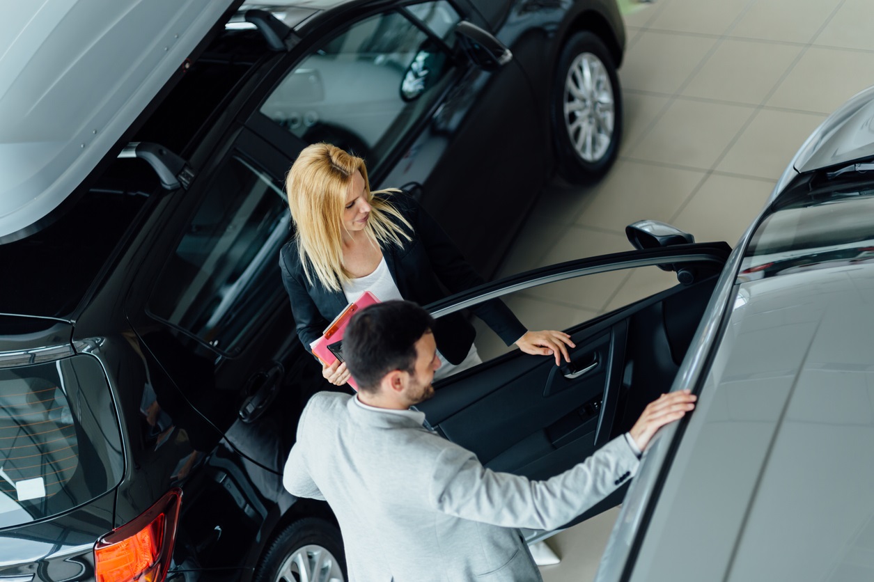 Customer looking for a car at dealership and customizing vehicle