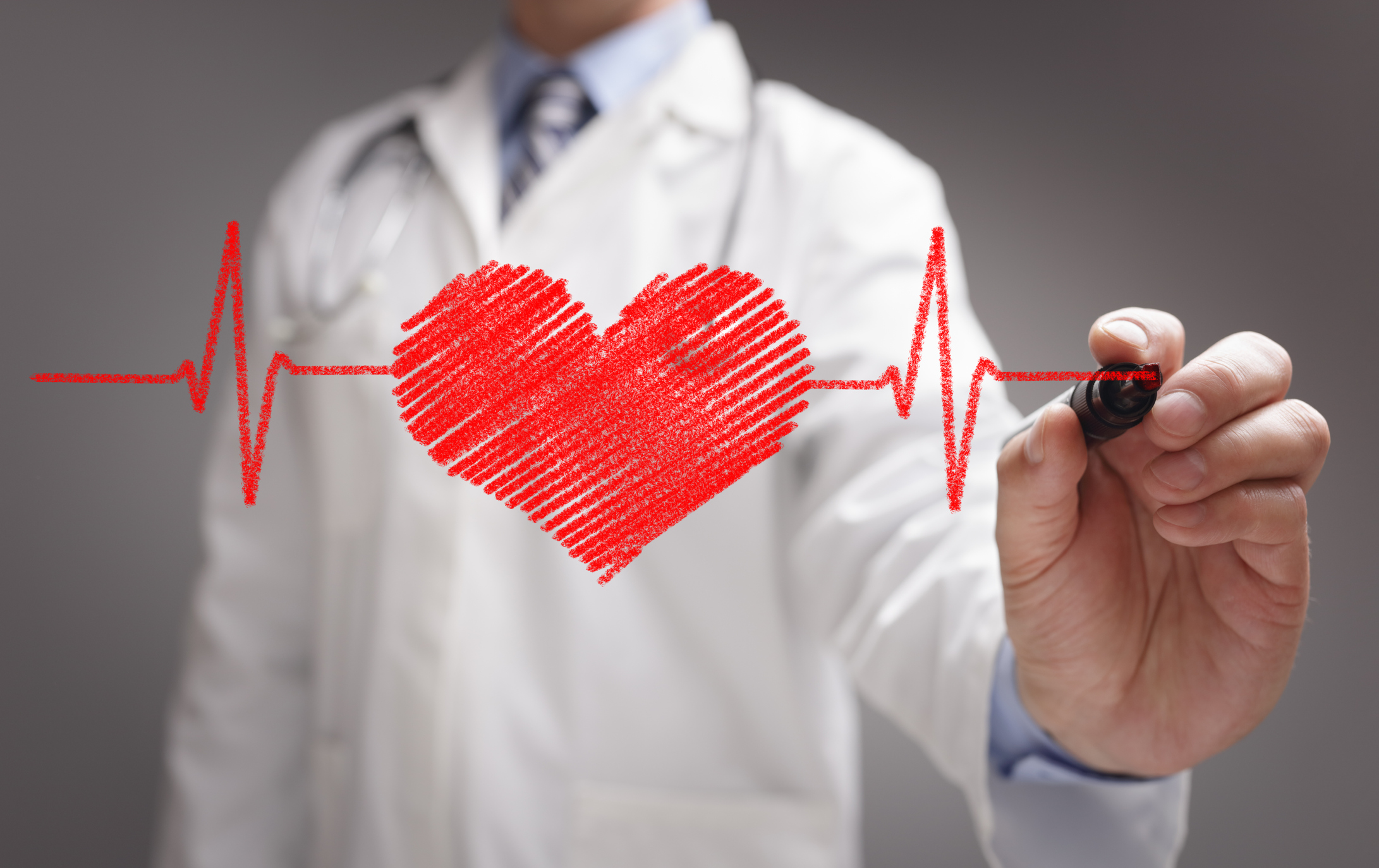 Doctor drawing ecg heartbeat chart with marker on whiteboard concept for healthcare and medicine